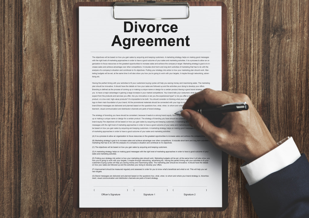 A person signing a divorce agreement