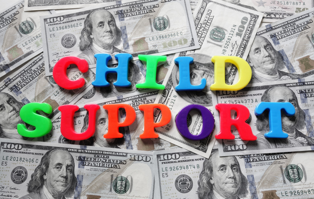 Colorful letters spelling out Child Support on paper bills